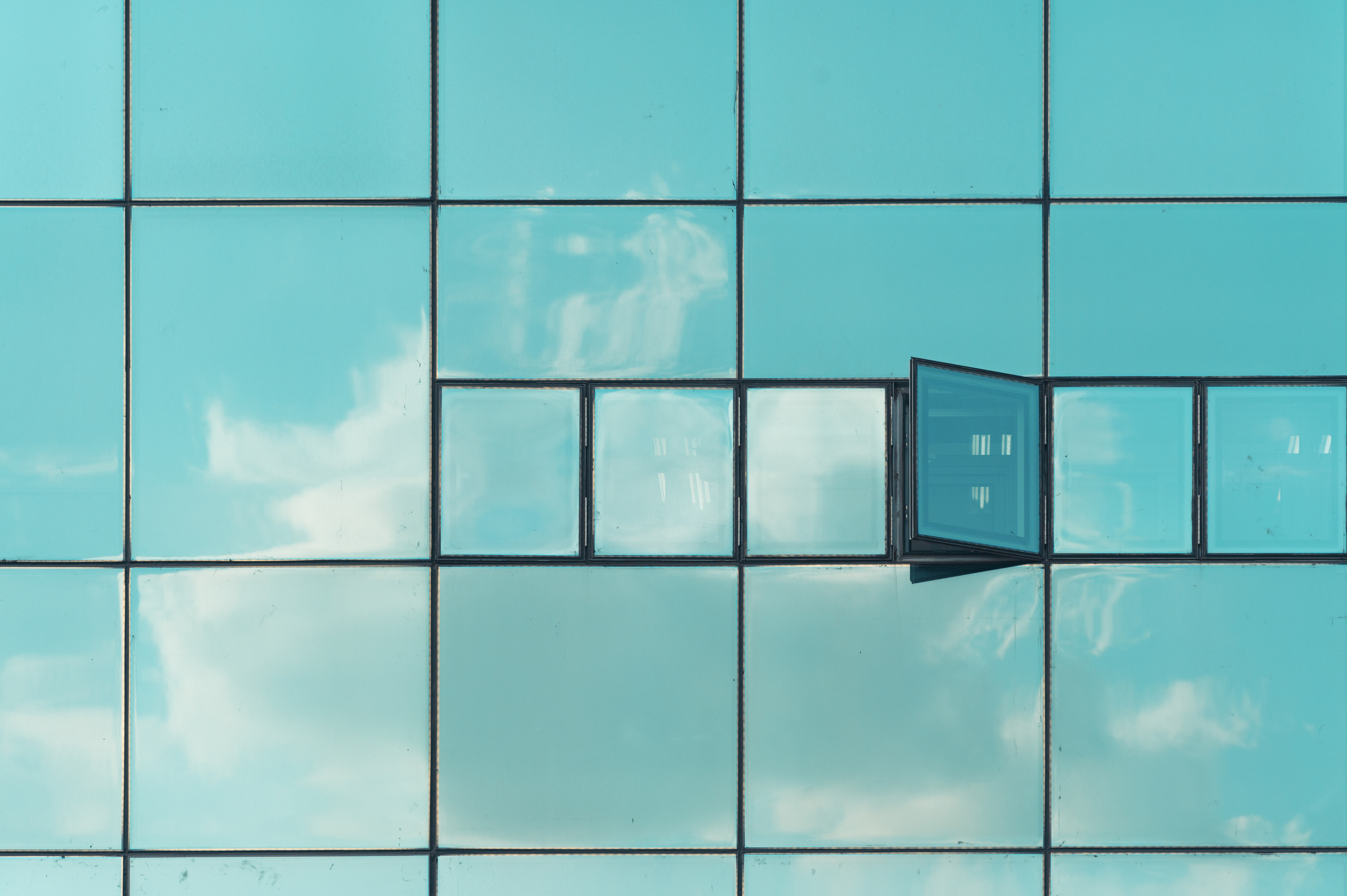 Open Glass Window with Reflection of Sky